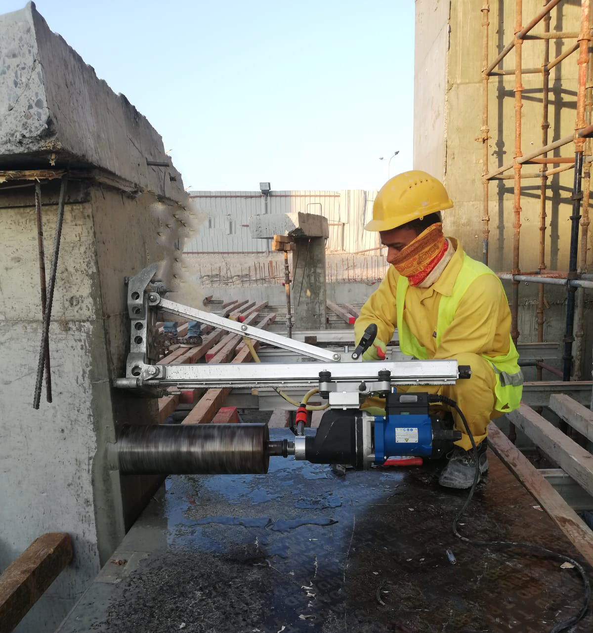 Concrete core drilling operation showing diamond bit cutting through reinforced concrete slab in Qatar