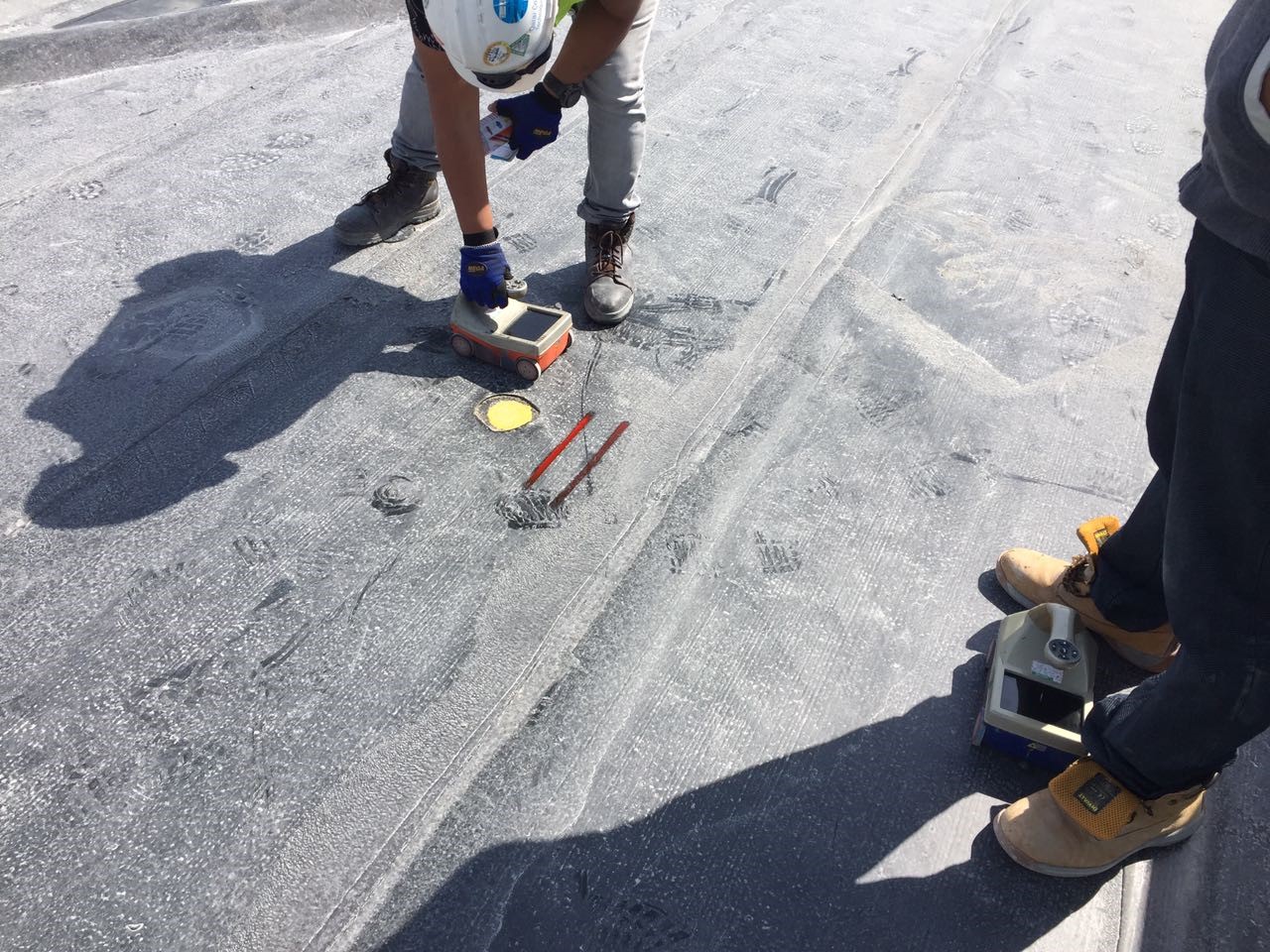 A site engineer interpreting Ground Penetrating Radar data on a concrete slab in Doha
